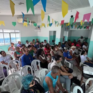 moradores da comunidade sentados durante a reunião