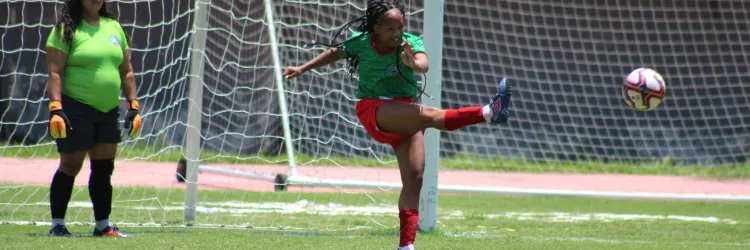 menina chutando bola